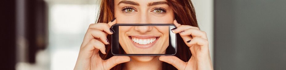 woman smiling after wearing veneers