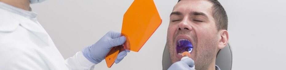 dentist performing dental sealants